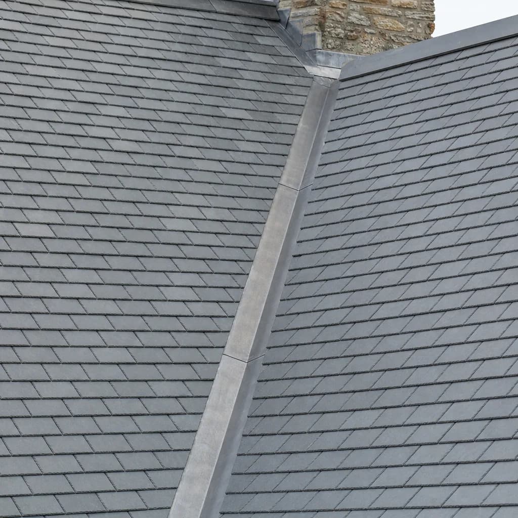 Natural grey slate roof with uniform courses and a lead valley